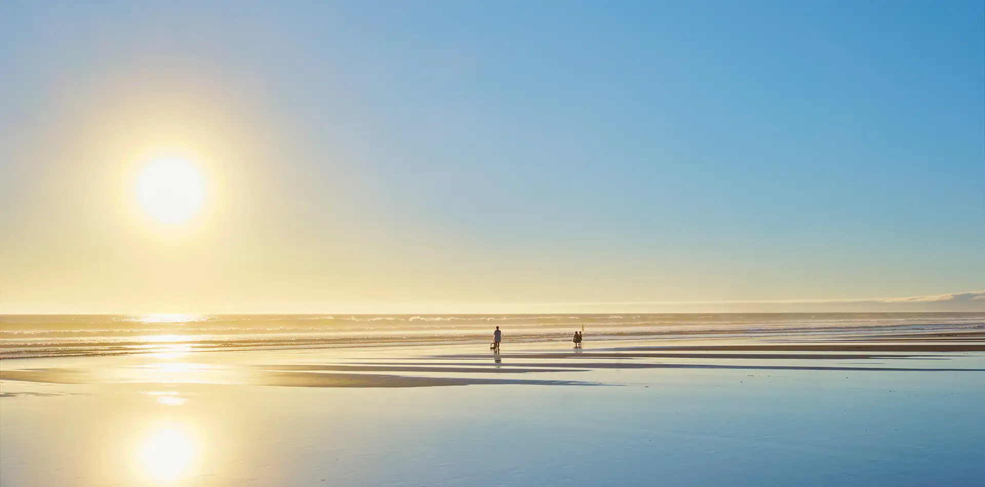 A bright morning beach scene with people in the ocean doing group exercise