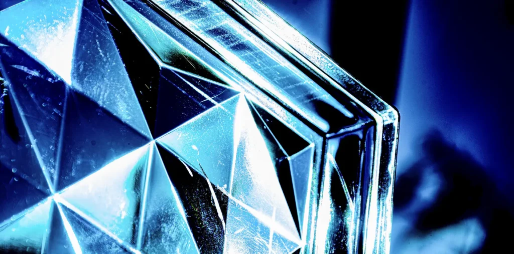 A macro photograph of a glowing, symmetrical water crystal