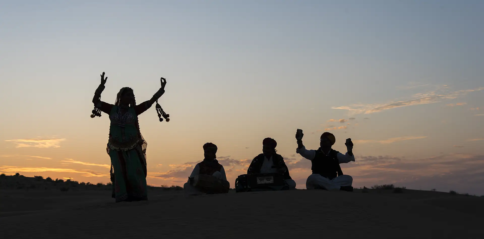 A peaceful sunrise ritual scene: a person sitting quietly at the edge of a cliff on Kauai, soft golden light, subtle clouds, calm mood — representing daily spiritual ritual.