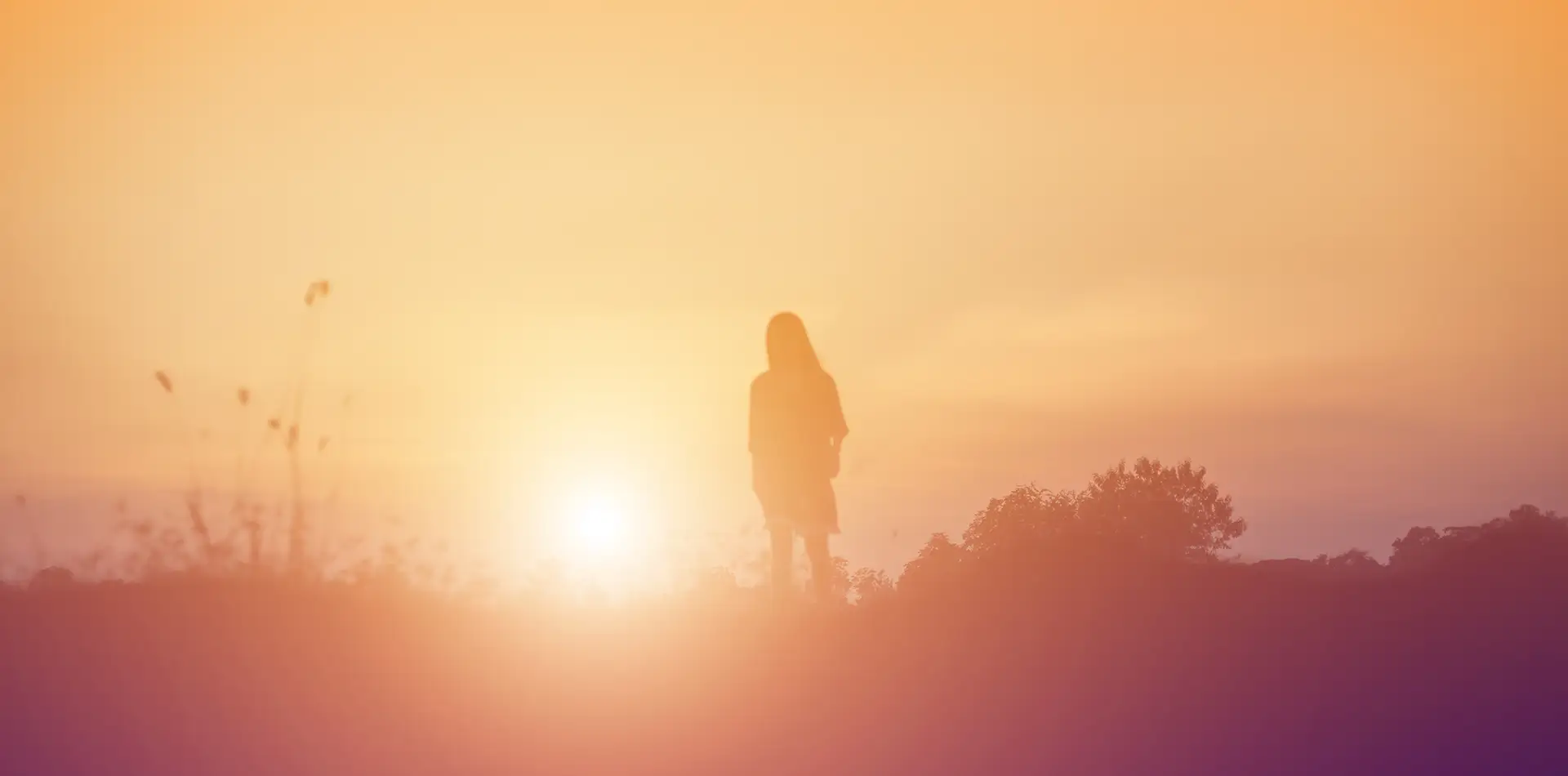 A softly glowing silhouette or translucent human figure bathed in warm golden-white light