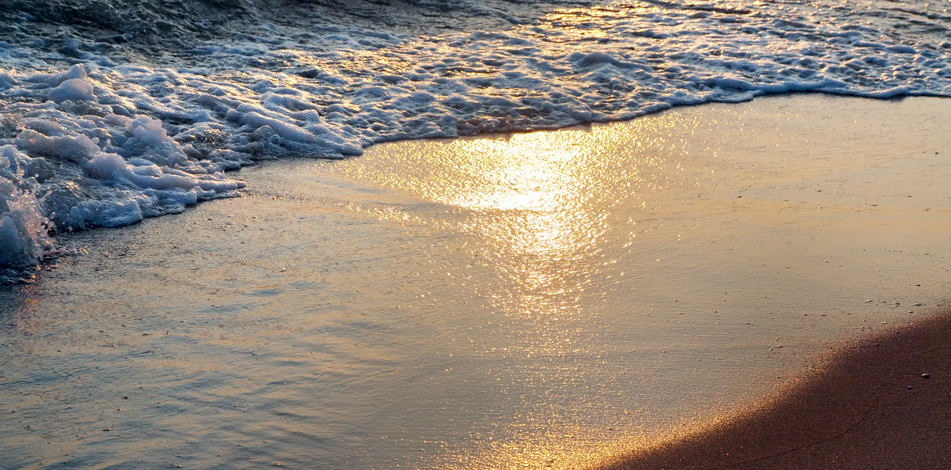 A serene beach scene at sunset with gentle waves
