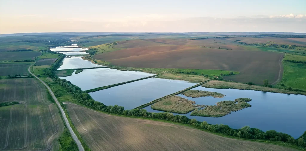 Restored land and flowing water symbolizing consciousness and learning from the past