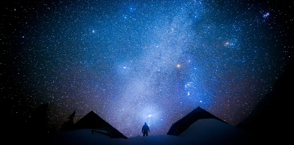 Person contemplating the universe, symbolizing consciousness and the search for meaning.