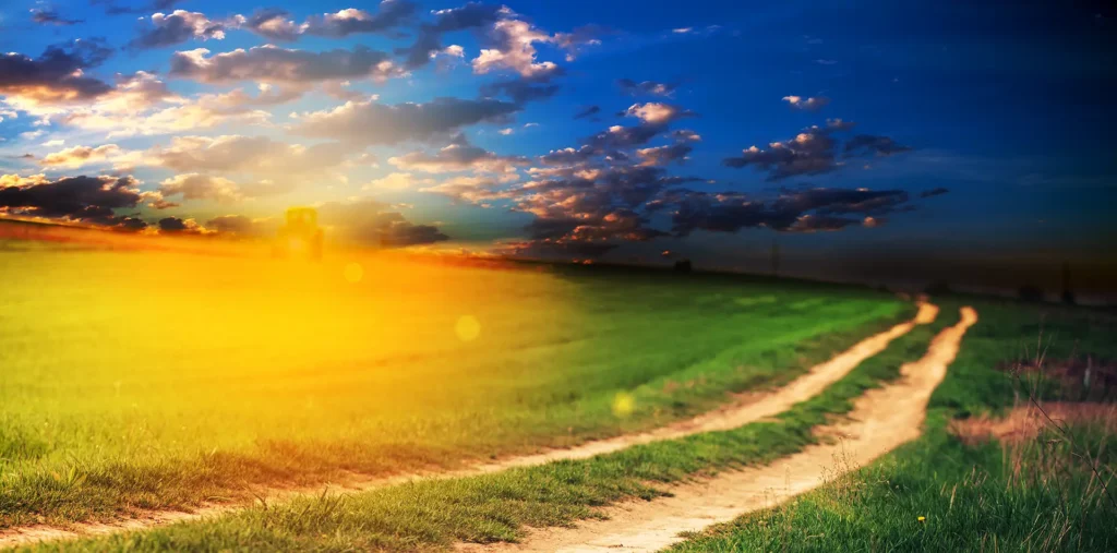 A wide panoramic view of a soft, golden path of light stretching through a serene landscape, representing the spiritual search for something real to believe in.