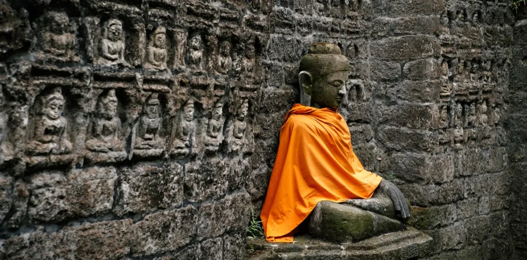 A person sits in deep meditation surrounded by ancient spiritual texts, symbolizing the link between old wisdom and new consciousness.