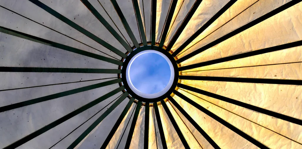 Colorful light streams through a window, hitting a quiet room and showing how old traditions and new energy ideas can live together.