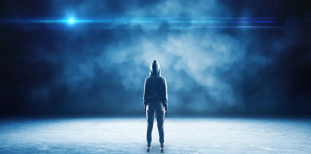 A glowing, transparent figure walks through a vibrant, colorful world that looks like a lucid dream.