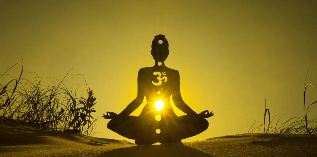 A person experiencing the way of consciousness through meditation in nature under golden sunlight.