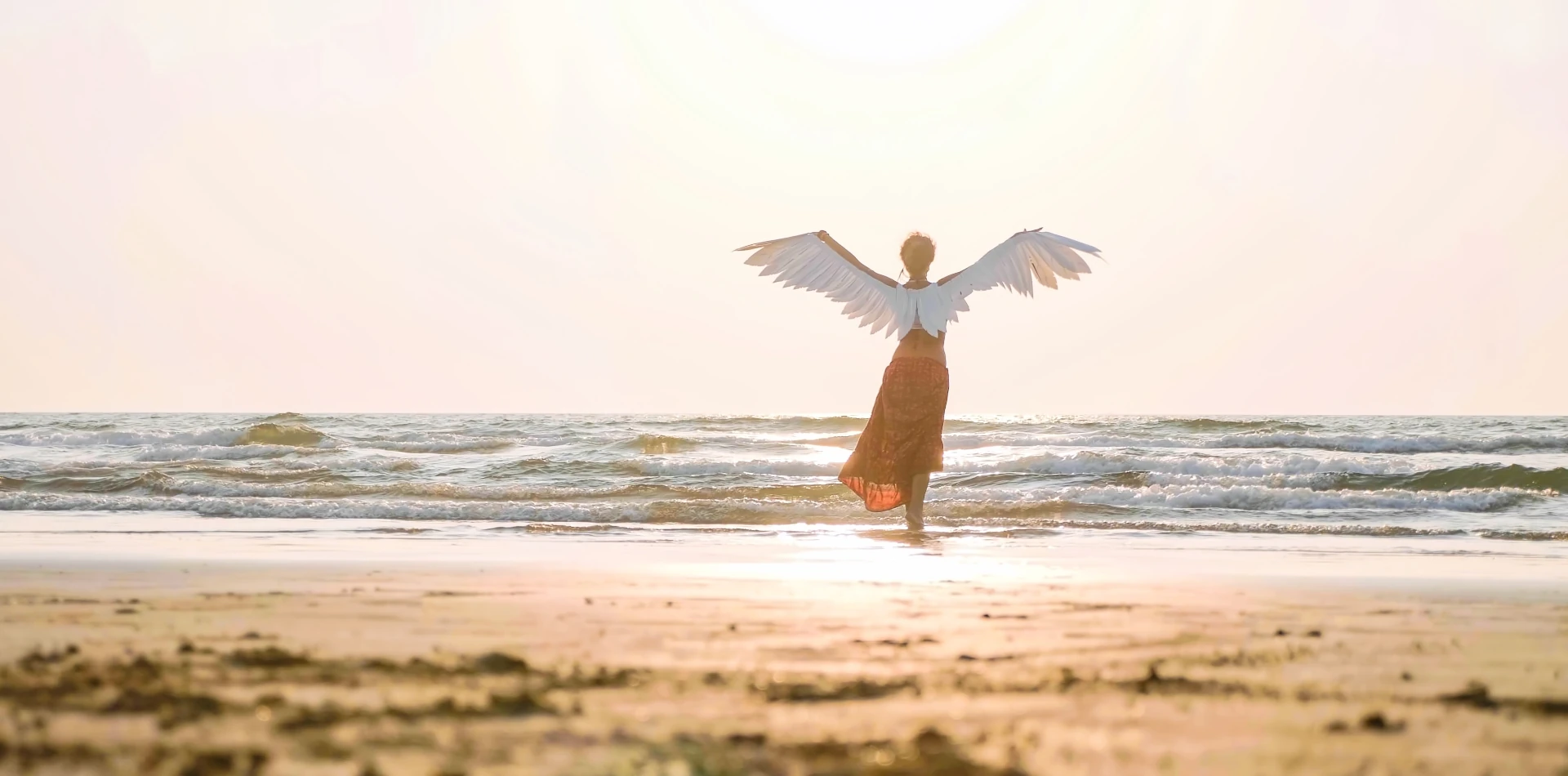 Glowing angel with golden wings representing spirit guides and divine energy