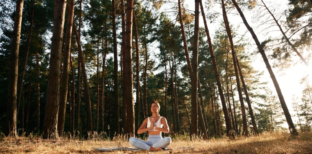 Person meditating in nature with golden light, symbolizing spiritual self-discovery and life's calling