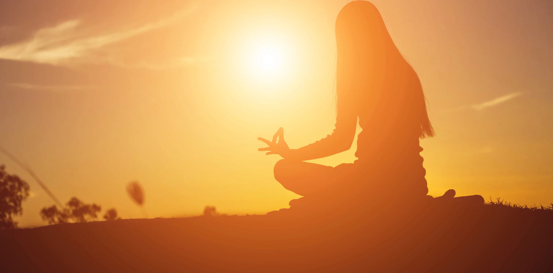 Person meditating in warm golden light symbolizing conscious awakening and positive mindset