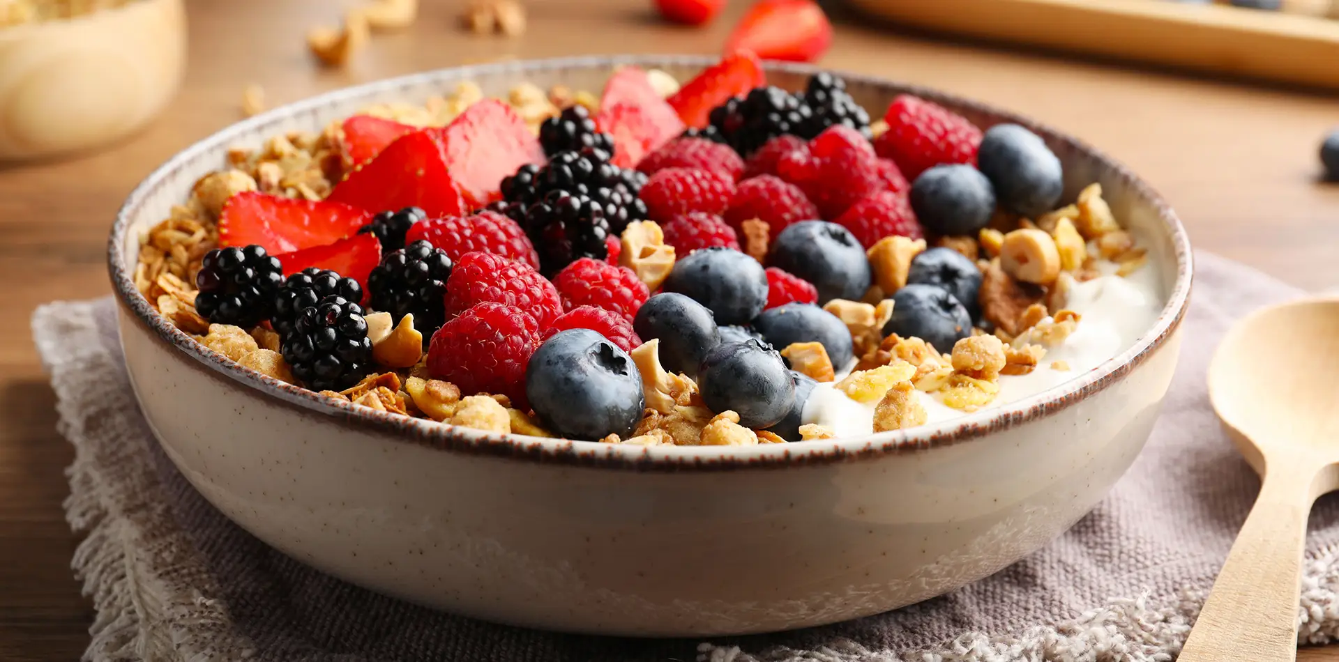 A nourishing breakfast bowl with oats, seeds, and berries on a rustic wooden table in soft morning light