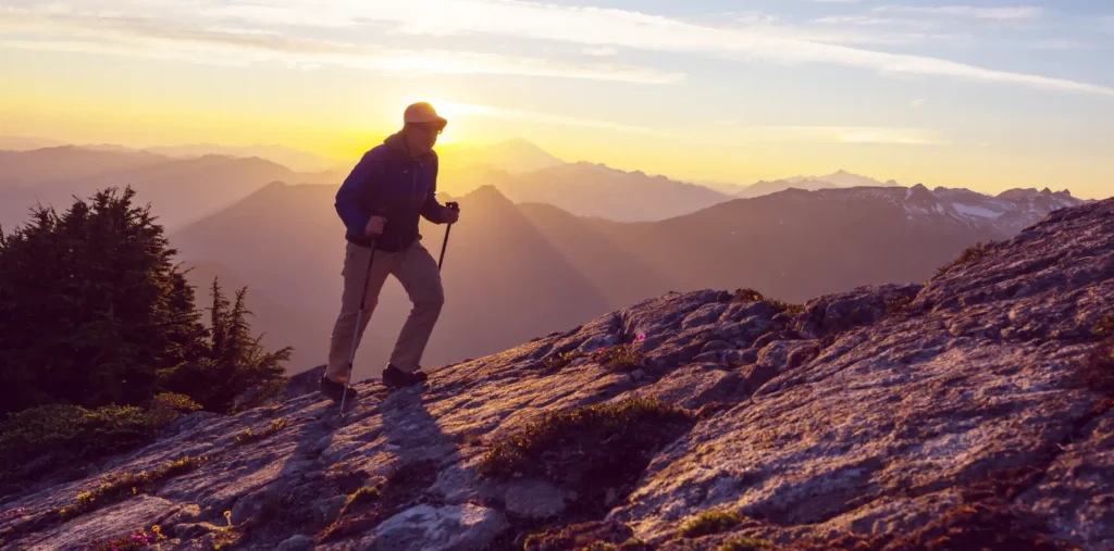 An older adult hiking in nature, reflecting on spirituality and health