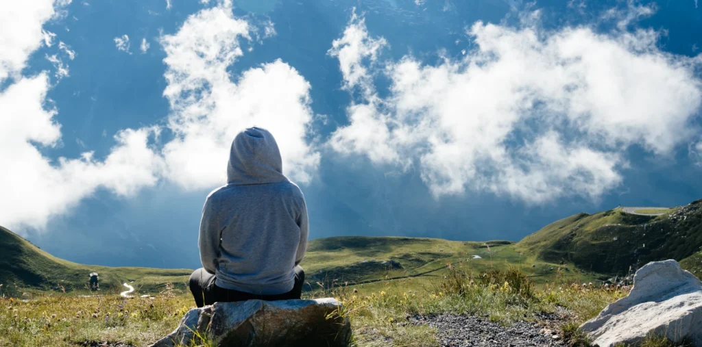 Person meditating in golden light representing a conscious spiritual life and inner energy