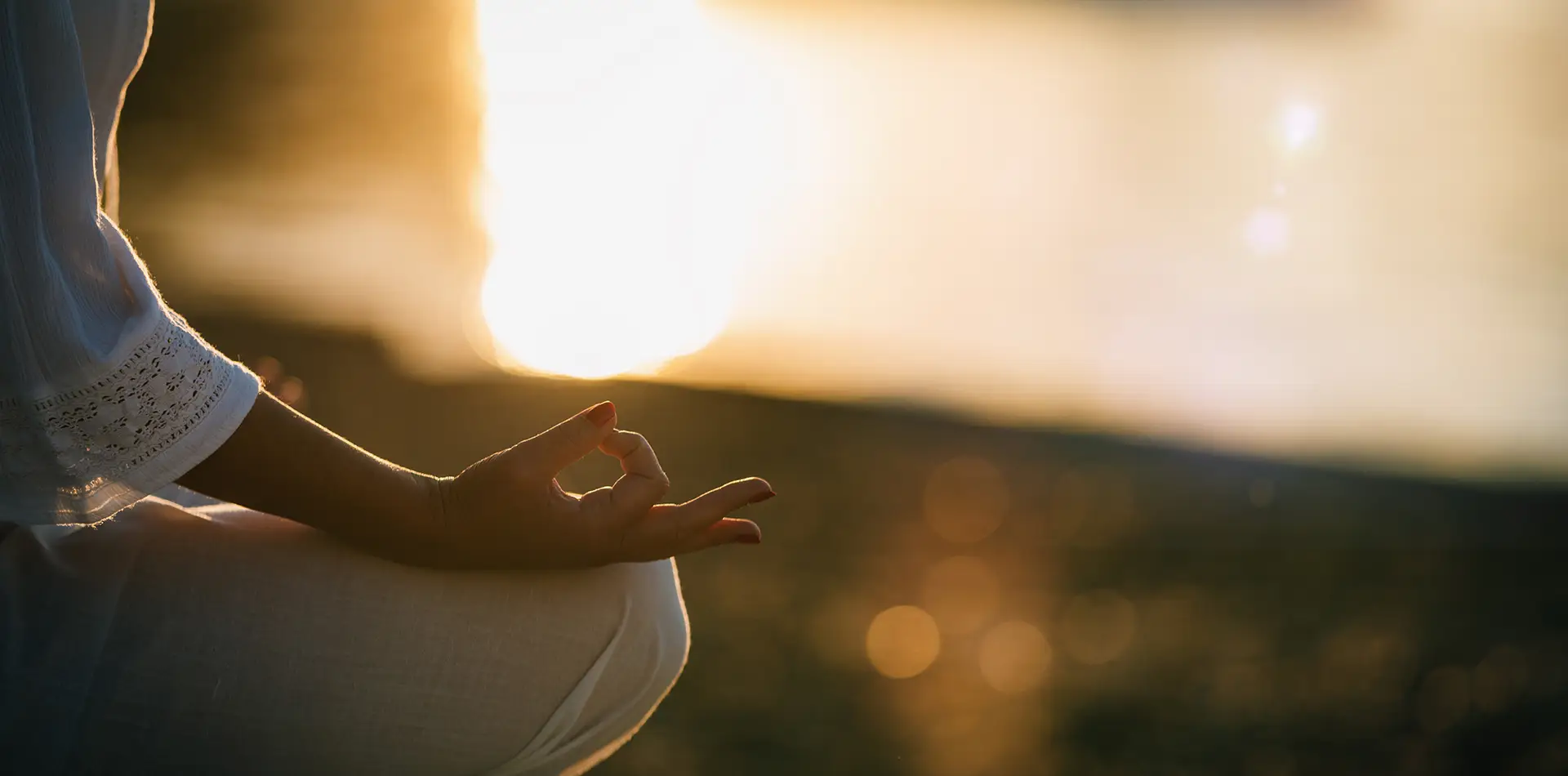 Person meditating in a glowing circle of golden light representing spiritual unity and atonement