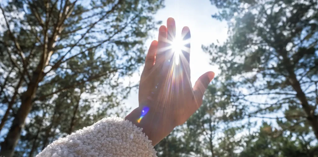 Hands open and glowing with warm light, symbolizing love and universal energy
