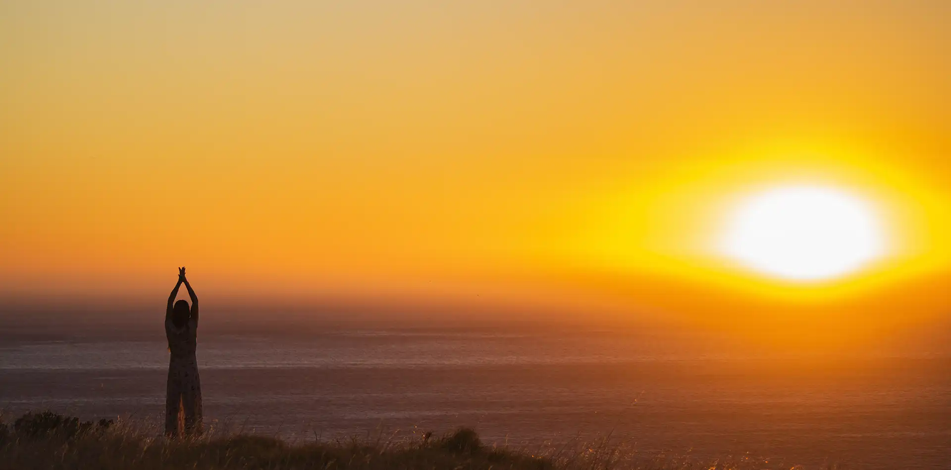 A figure bathed in warm golden light at dawn, symbolizing the inner glory that lives within all of us
