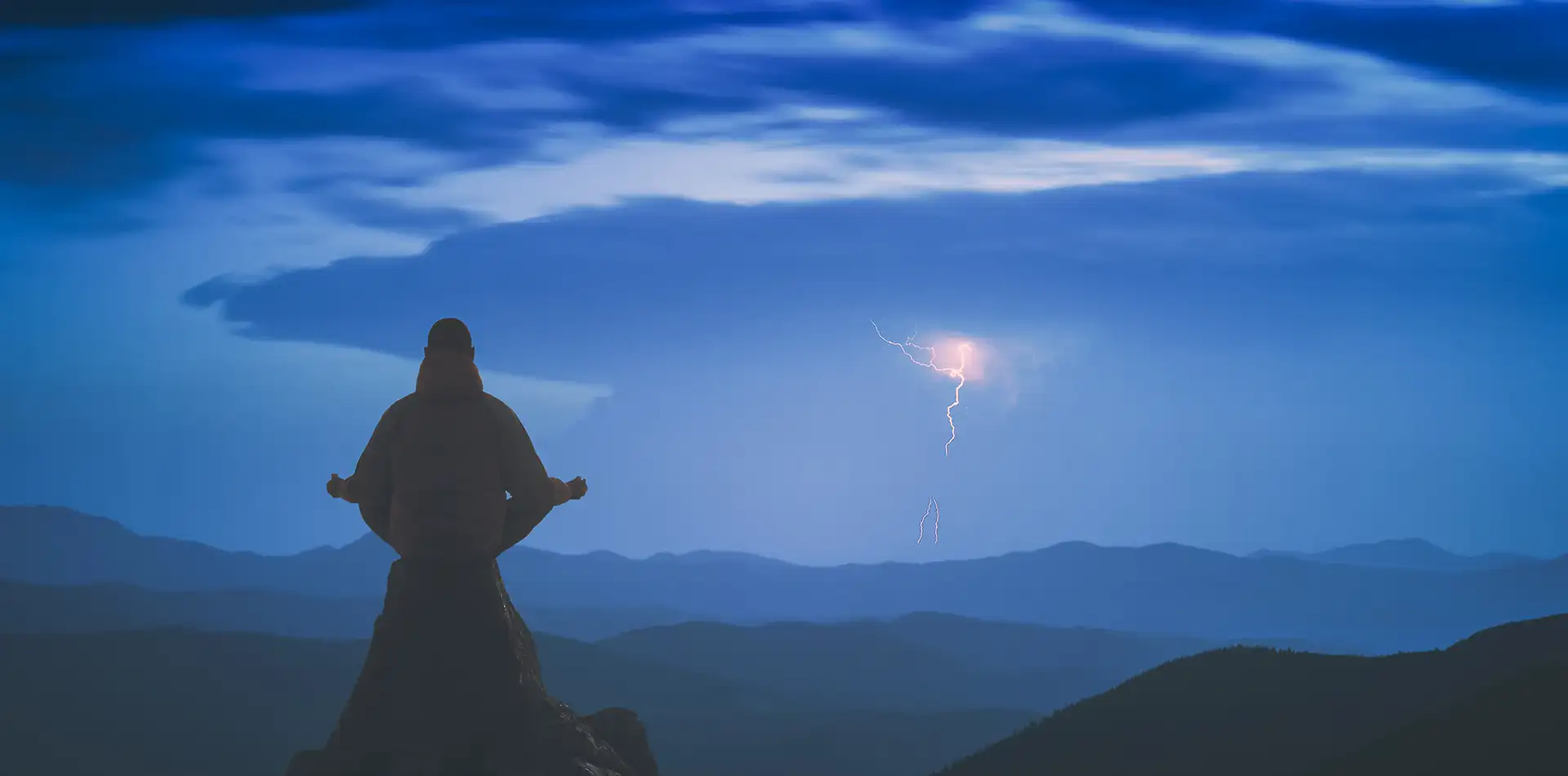 Person meditating on a hilltop at sunrise, symbolizing higher consciousness, love, and peace