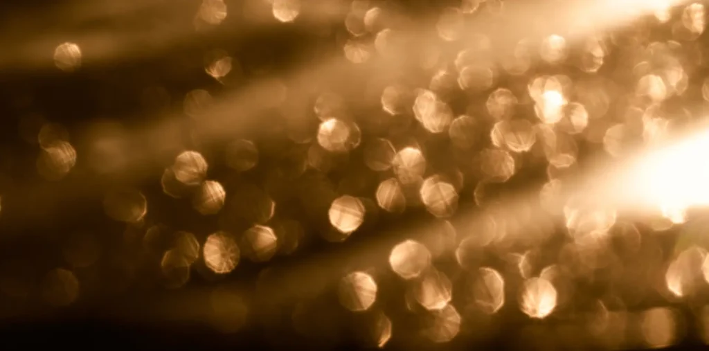 Glowing golden orbs of light rising through a dark ethereal space representing souls in the spiritual world