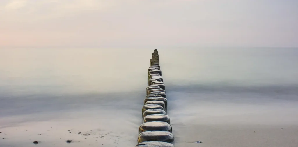 Stone steps ascending a misty mountainside at dawn, symbolizing the climb toward enlightenment on the path that leads upward