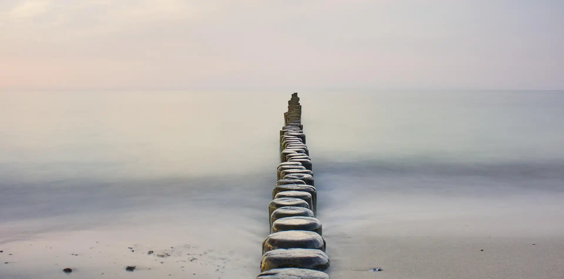 Stone steps ascending a misty mountainside at dawn, symbolizing the climb toward enlightenment on the path that leads upward