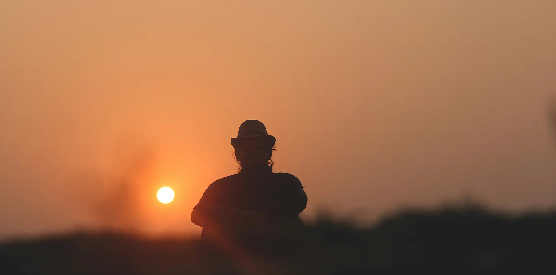 Person in meditation with a glowing core star of light representing love, peace, and spiritual connection to God and nature